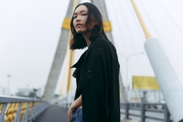 Teenage woman stood on bridge